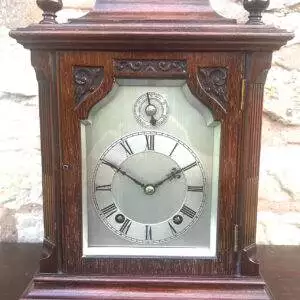 Perfect timepiece for any home this clock is made of solid mahogany with fretted sides. W & H movement.