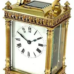 Beautiful antique carriage clock of architectural design. The case is flanked by Corinthian pillars and has loverly fretted style motif top and bottom borders and 4 finials