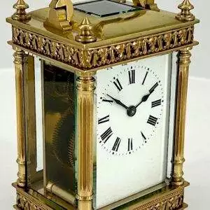 Beautiful antique carriage clock of architectural design. The case is flanked by Corinthian pillars and has loverly fretted style motif top and bottom borders and 4 finials