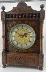 Victorian Carved oak bracket clock ca 1840. Wonderful original silver dial with a stunning ormolu detailed center piece, wonderful carved case with beautiful finials and bun feet all original to the period.