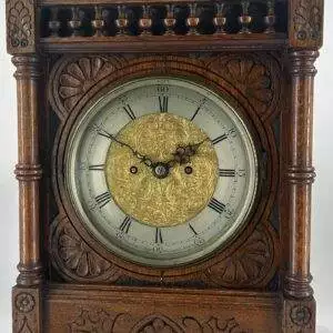 Victorian Carved oak bracket clock ca 1840. Wonderful original silver dial with a stunning ormolu detailed center piece, wonderful carved case with beautiful finials and bun feet all original to the period.