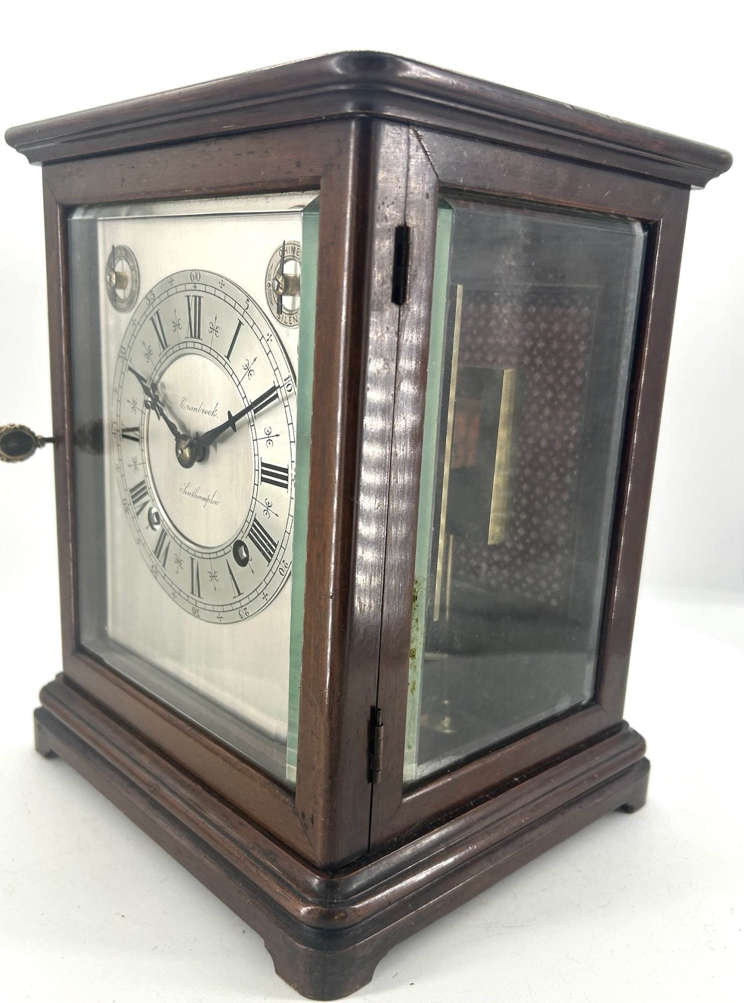 Lovely Victorian Bracket clock ca 1980. Wonderful, clean original silver dial with roman numerals and ornate hands. The case has 3 glass panels, and a viewing window on the top. The back door has a brass fretwork and cloth panel