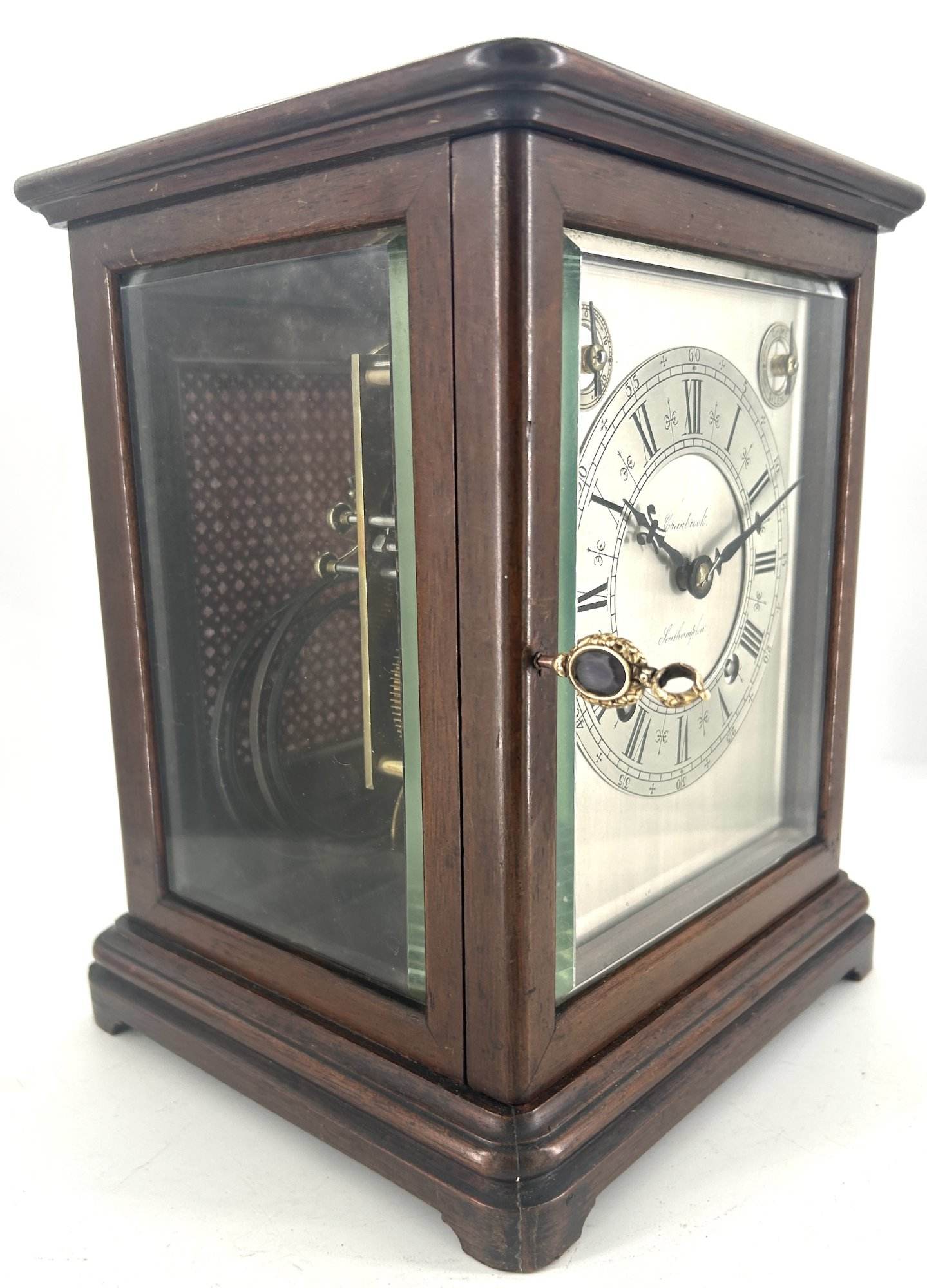 Lovely Victorian Bracket clock ca 1980. Wonderful, clean original silver dial with roman numerals and ornate hands. The case has 3 glass panels, and a viewing window on the top. The back door has a brass fretwork and cloth panel
