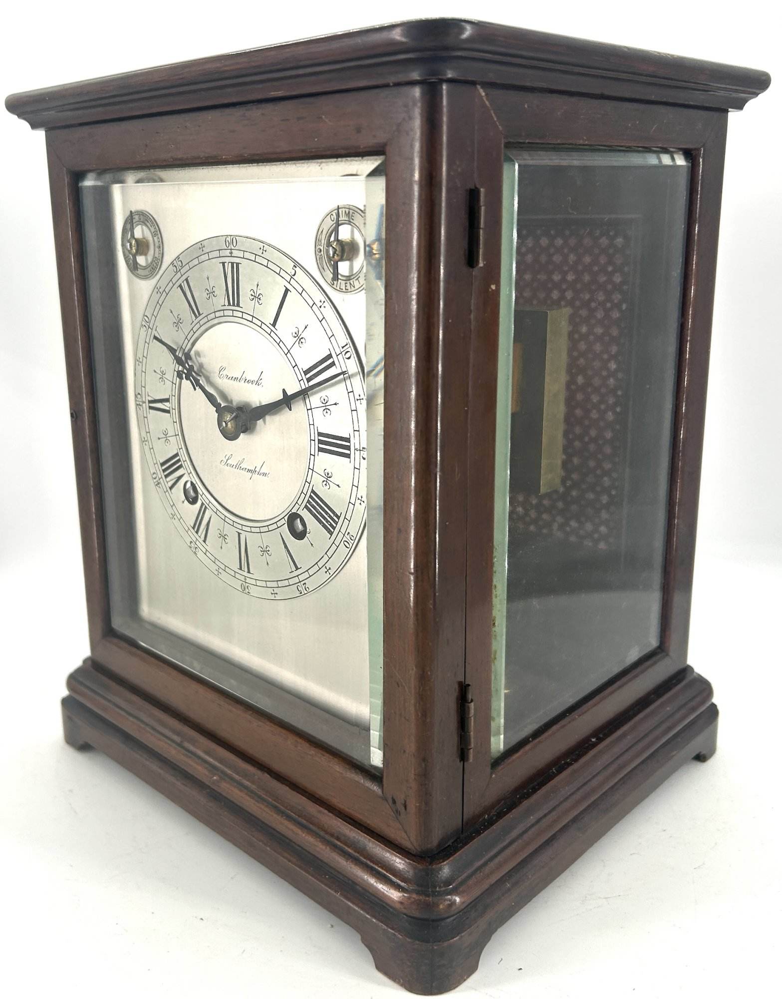 Lovely Victorian Bracket clock ca 1980. Wonderful, clean original silver dial with roman numerals and ornate hands. The case has 3 glass panels, and a viewing window on the top. The back door has a brass fretwork and cloth panel