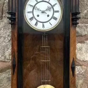 Fantastic Walnut Case Vienna wall clock ca 1890. Original enamel dial with original ornate foliate hands. The movement is an 8 day gong striking movement. The case is made of walnut with turned finials and pillars and figural ladys face below a fantastic architectural top pediment.